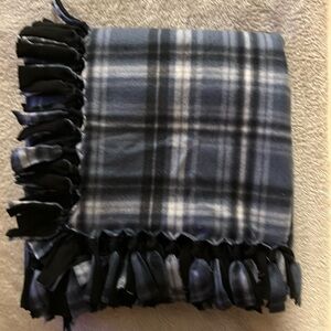 50x60” fleece tie blanket. Blue plaid fleece with black fleece backing